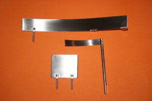Reground metal parts showing the rivets with chrome plating removed
